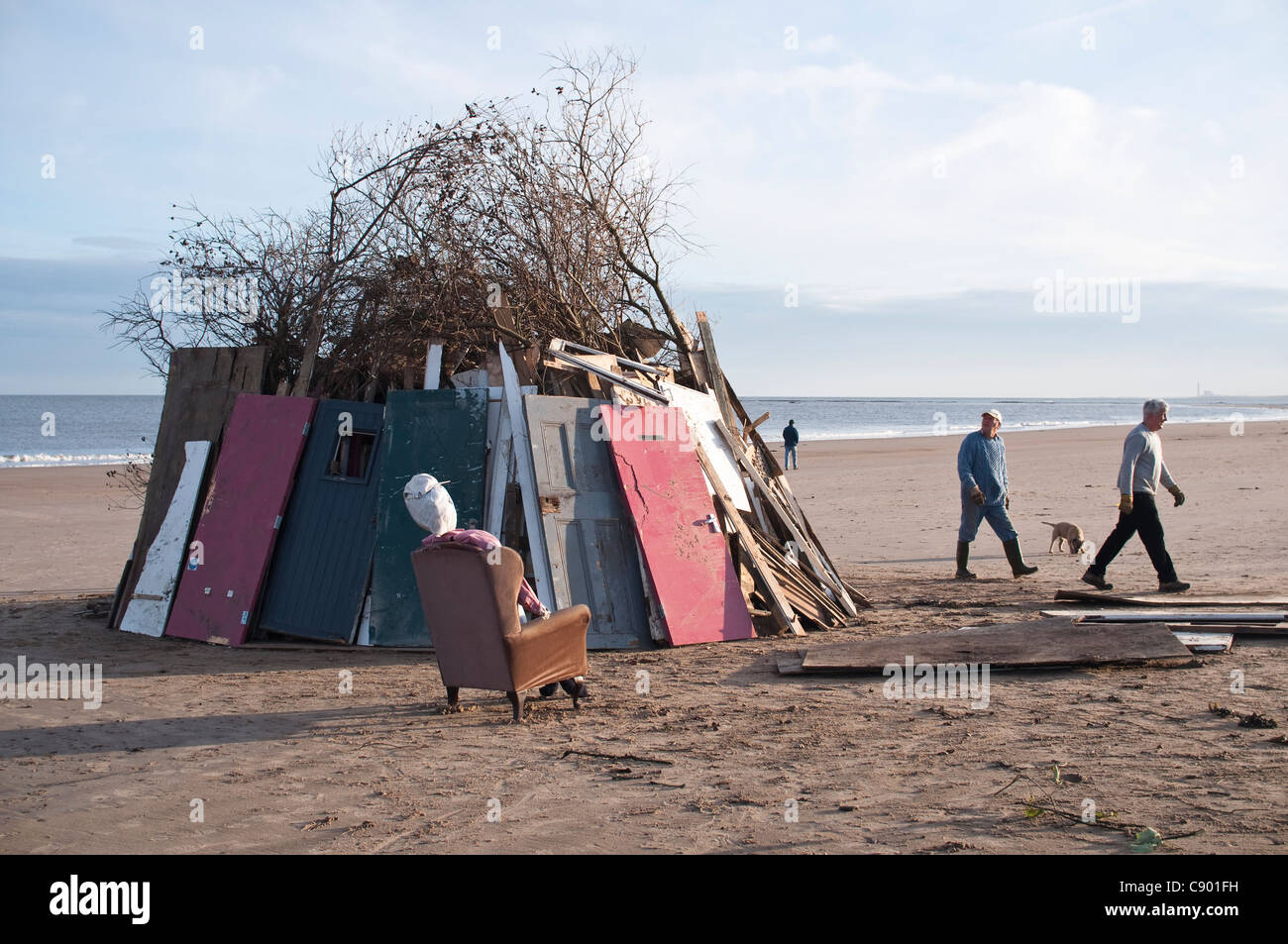 Building a large bonfire on the beach near Low Hauxley in Northumberland, UK, on November 5th to celebrate Guy Fawkes Night. Stock Photo
