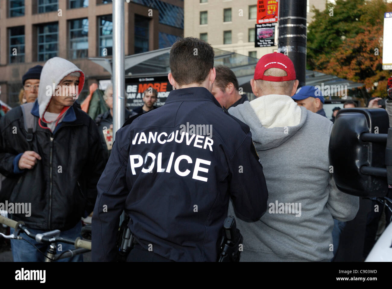 Police remove one of the photographers after getting into a scuffle with a protester from 'Occupy Vancouver'. Vancouver November 5 2011 Stock Photo
