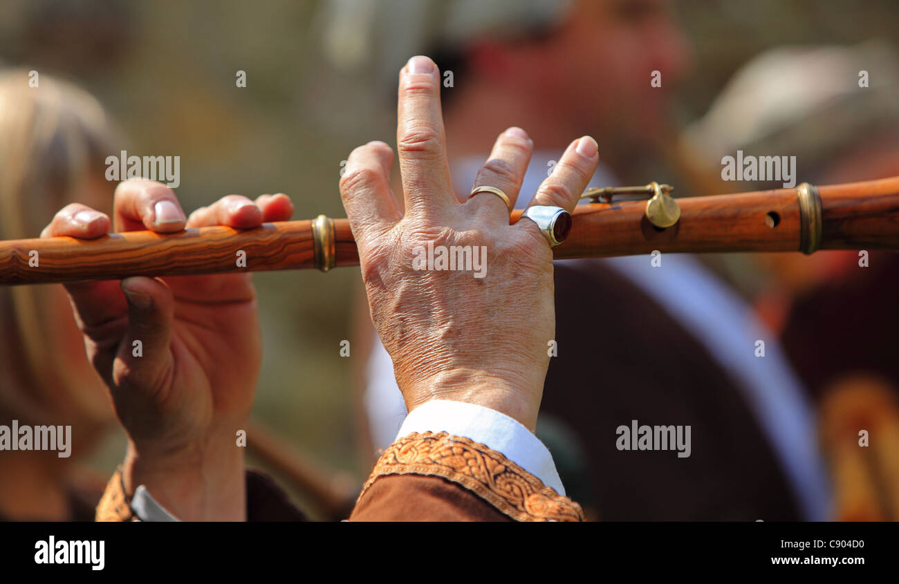 Detail of hands of a flute player during a medieval music performance