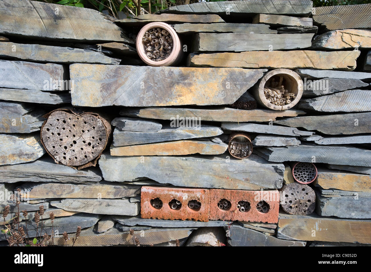 Insect hotel in a wall in The Centre for Alternative Technology, Llwyngern Quarry, Pantperthog, Machynlleth, Powys, Wales Stock Photo