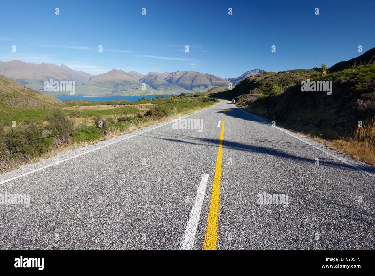 Makarora-Lake Hawea Road leading to Lake Wanaka and surrounding mountains, Otago, South Island, New Zealand Stock Photo