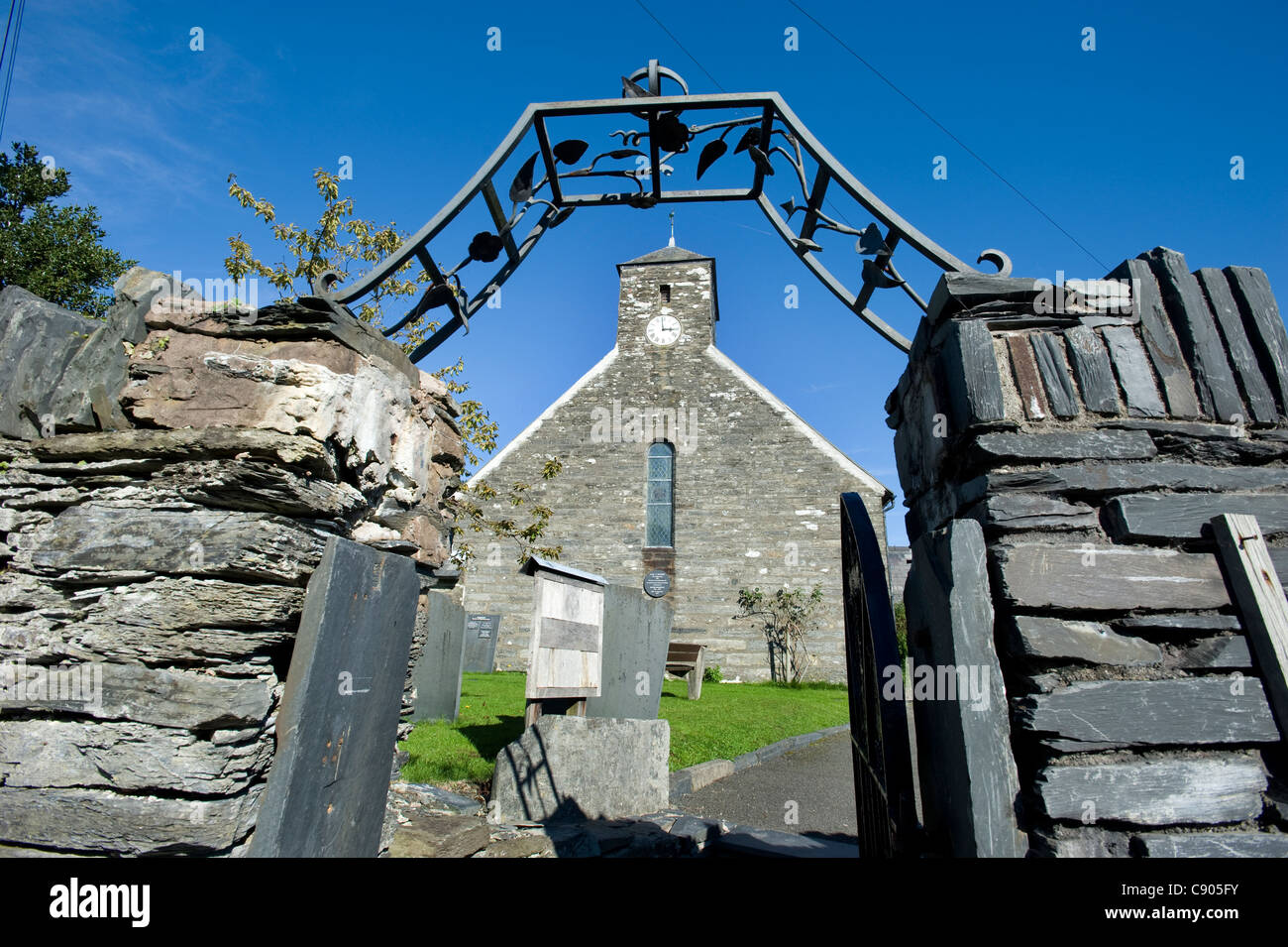 The wrought Iron entrance gate on a slate wall at St. Peter Ad Vincula Church in Pennal, Powys, North Wales.  The church dating from 1406 was Chapel Royal to Prince Owain Glyndwr. ( Owen Glendower ) Stock Photo