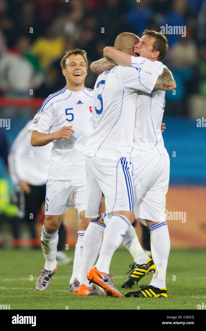 Slovakia players Radoslav Zabavnik, Martin Skrtel, and Jan Durica celebrate after defeating Italy in a 2010 World Cup match. Stock Photo