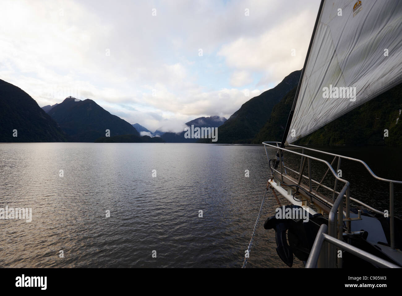 Beautiful scenery at dawn from bow of boat, Doubtful Sound, Fiordland National Park, South Island, New Zealand Stock Photo