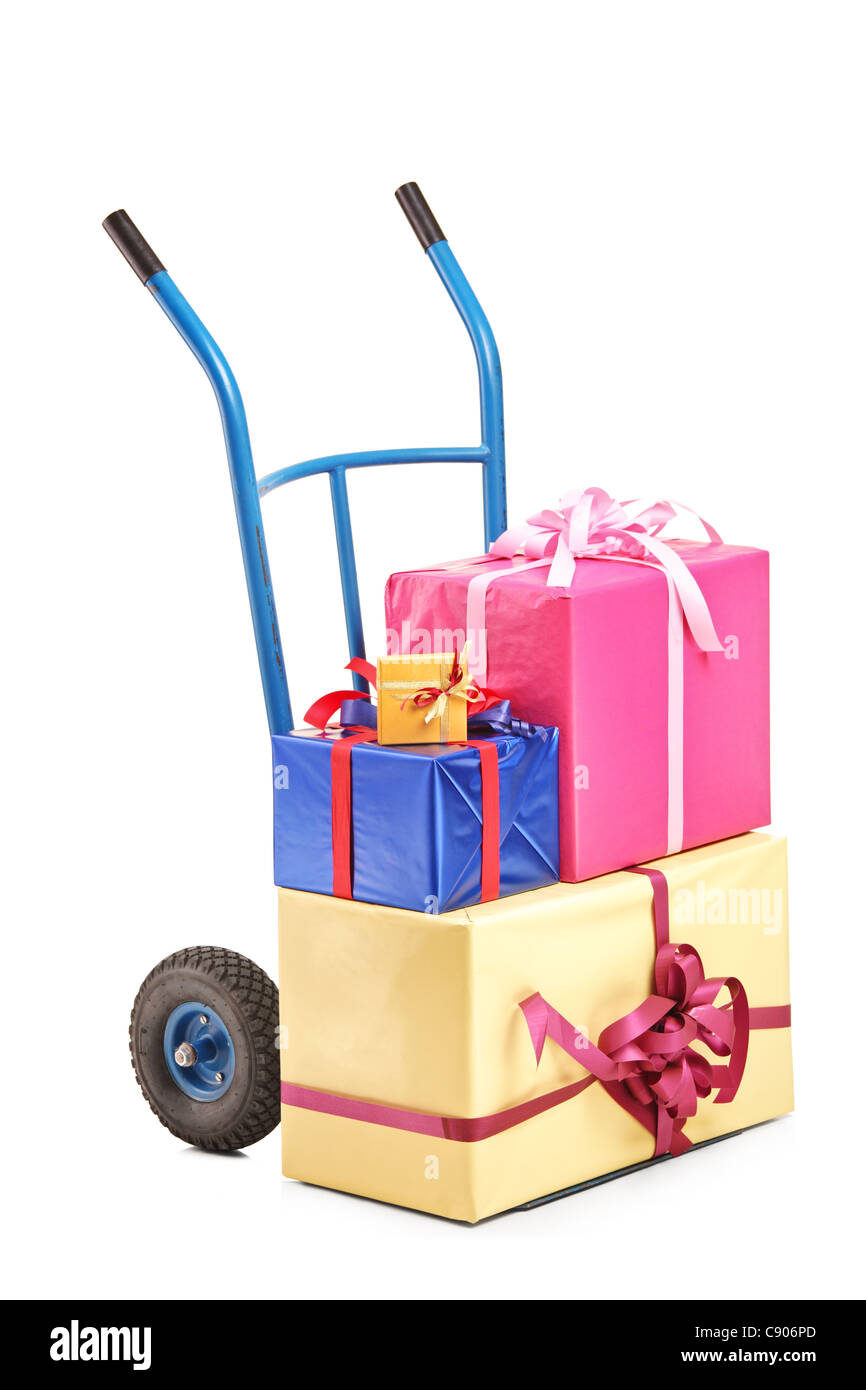 A studio shot of a hand truck with many gifts on it Stock Photo