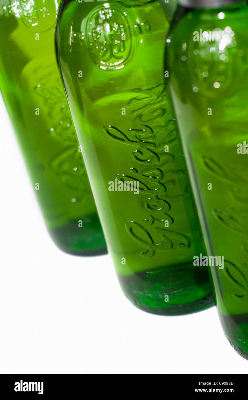 Three empty beer bottles against a white background Stock Photo - Alamy