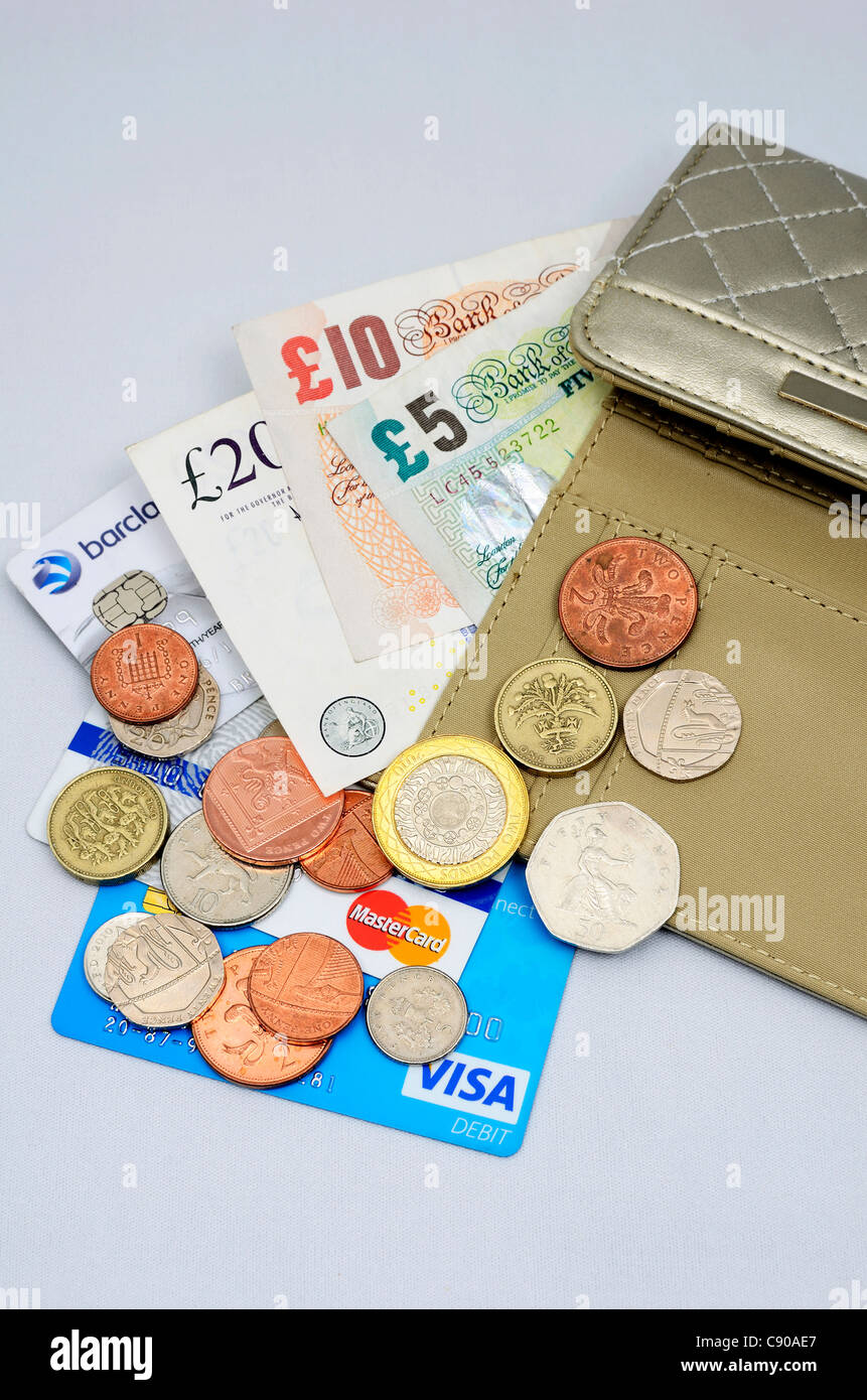 money and credit cards spilling out of a purse Stock Photo - Alamy