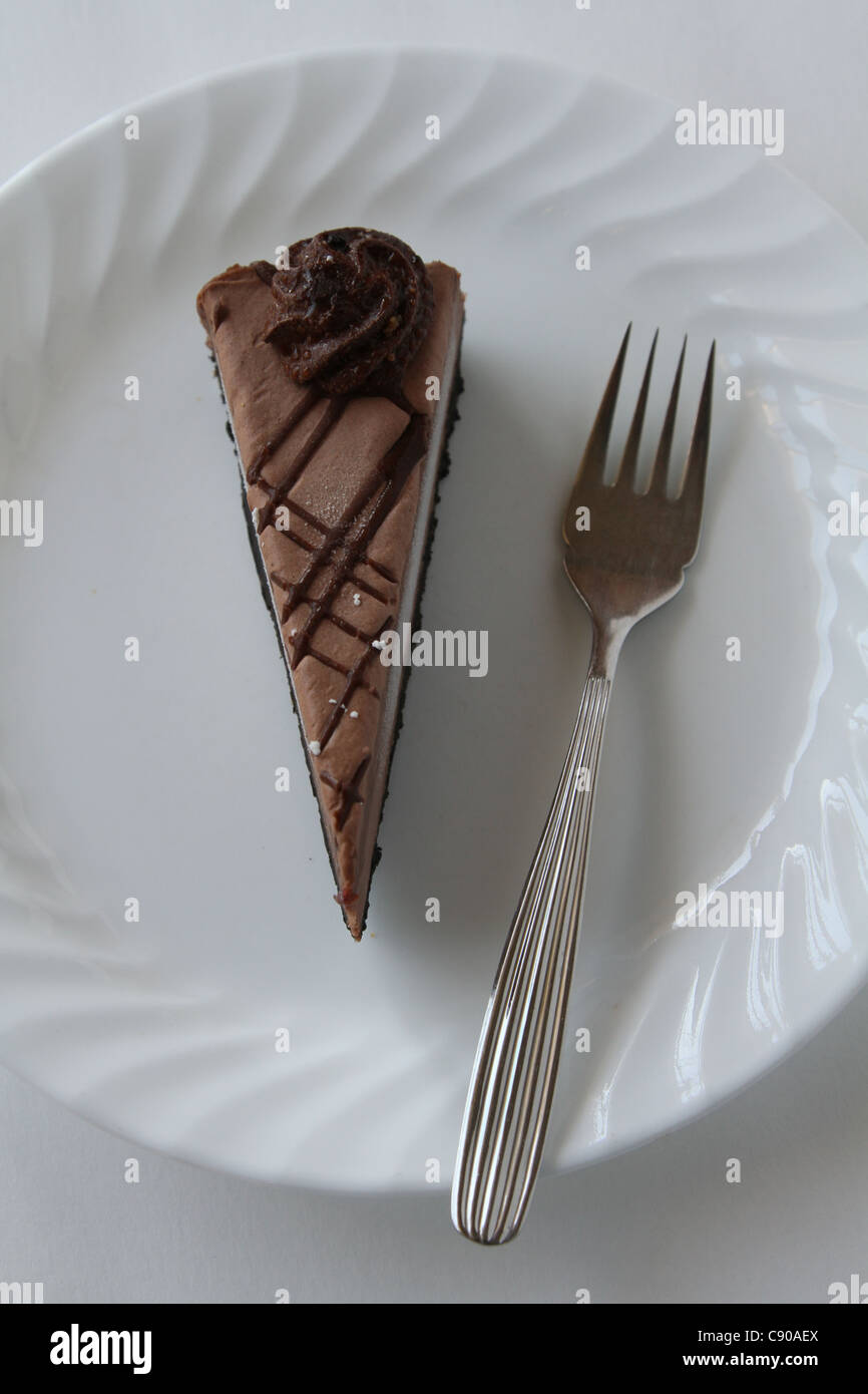 chocolate cheesecake slice white plate fork Stock Photo
