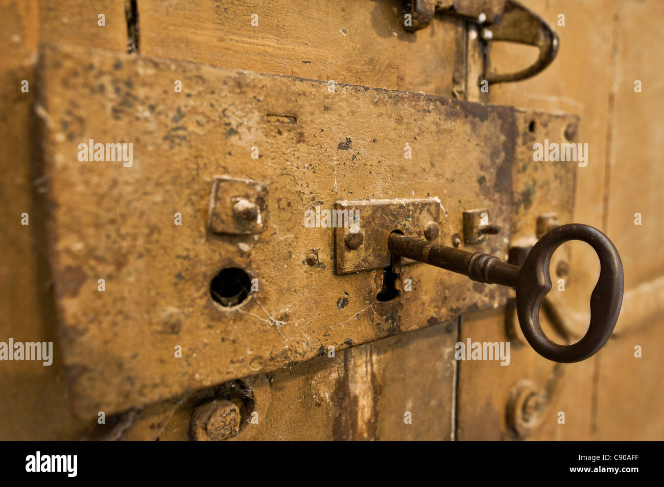 Old key in a door lock Stock Photo