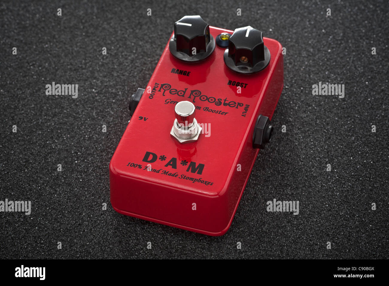 A RED ROOSTER effect pedal photographed in the studio. It is an effect unit designed to be turned on and off with the feet. Stock Photo