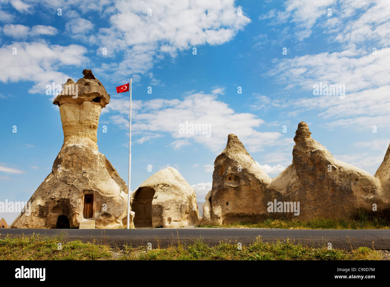 scenic landscape place of worship in Cappadocia Turkey limestone caves converted church ancient mid day sun blue sky clouds Stock Photo