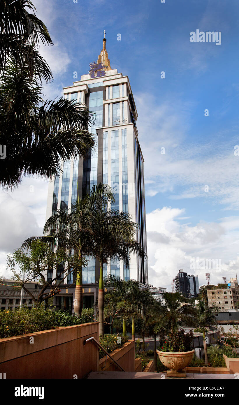 Editorial, Portrait vertical of United Breweries Building Bangalore India Tower corporate offices palm trees blue sky and clouds Stock Photo