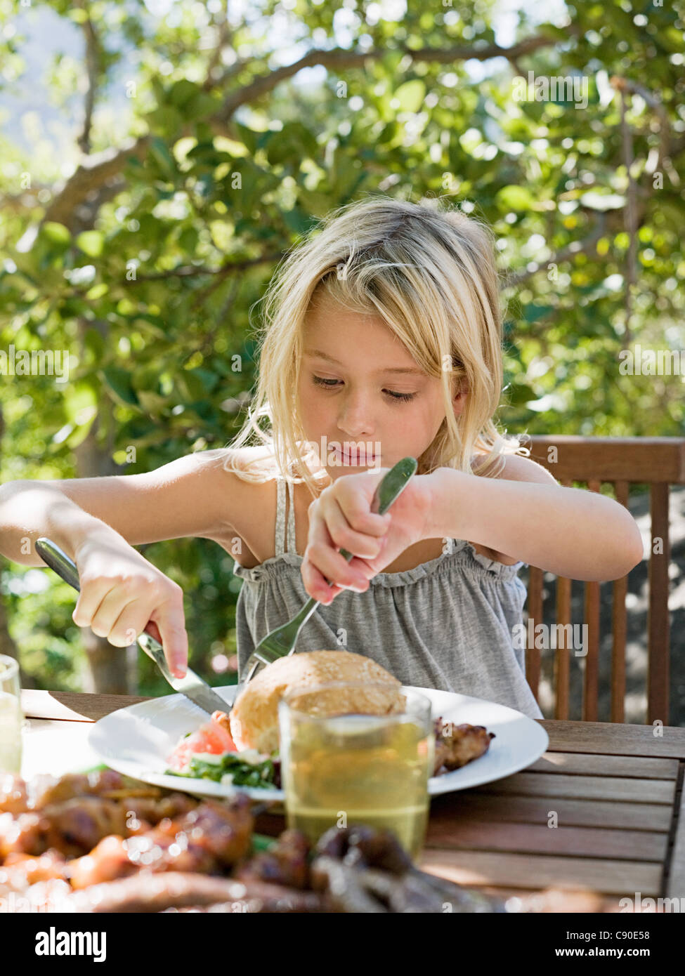 Girl eating meal, outdoors Stock Photo