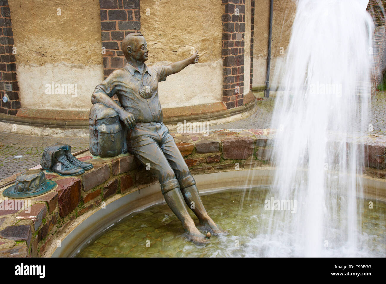 Fountain with sculpture of a pilgrim on the way to Santiago, Kaisersesch, Eifel, Rhineland-Palatinate, Germany, Europe Stock Photo