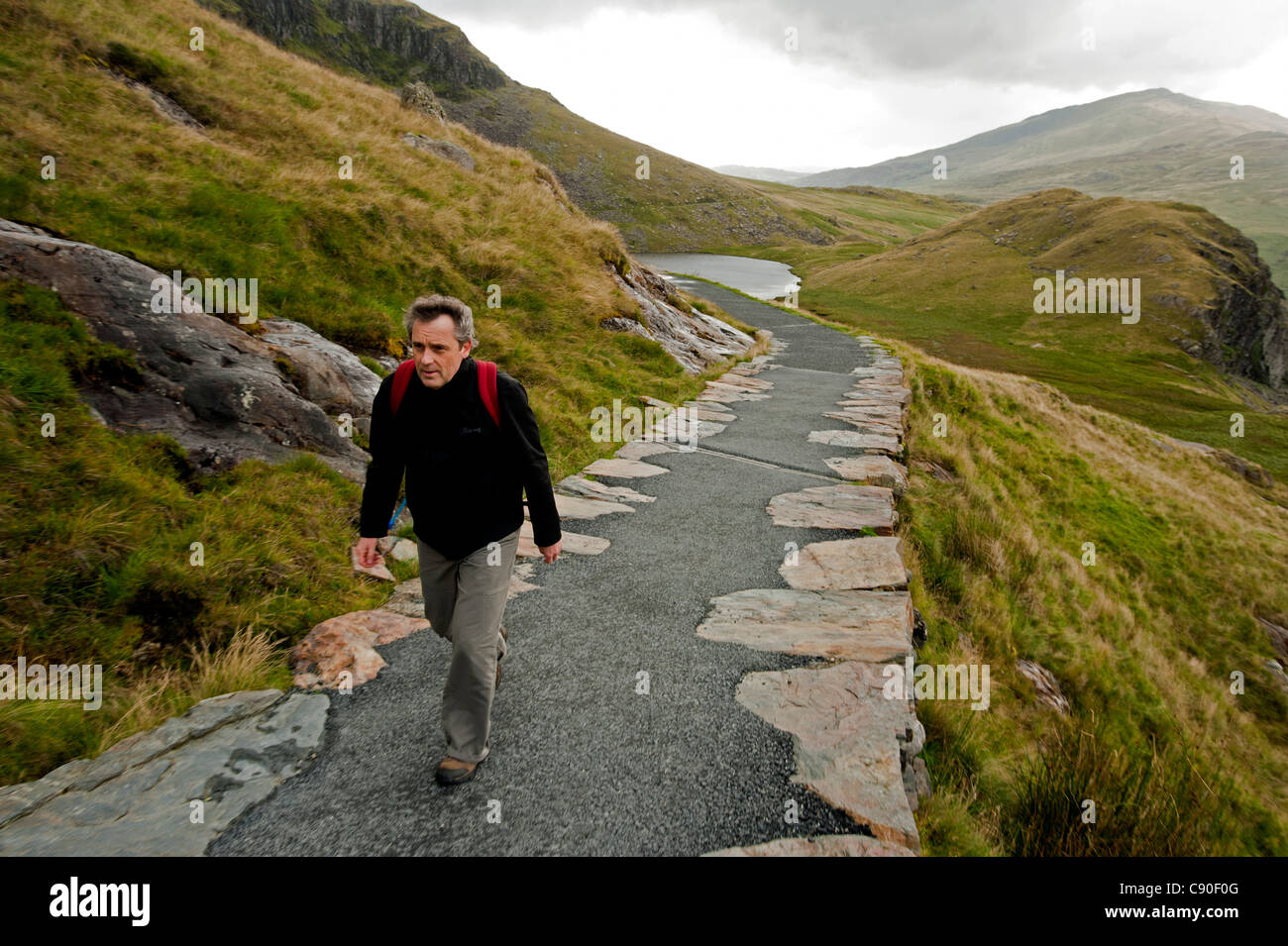 Hiker on the Miners Track towards Mt. Snowdon, Snowdonia National Park, Wales, UK Stock Photo