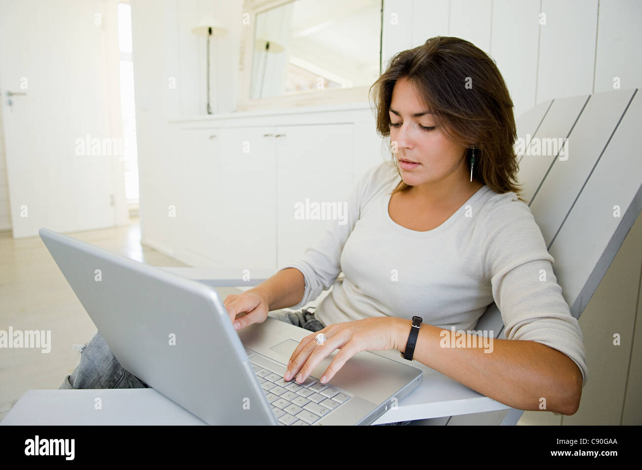 Woman using laptop at home Stock Photo