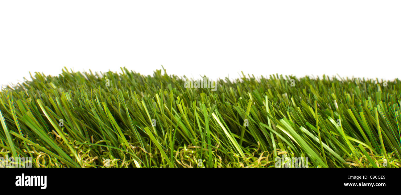 patch of manicured green artificial grass on a white background Stock Photo