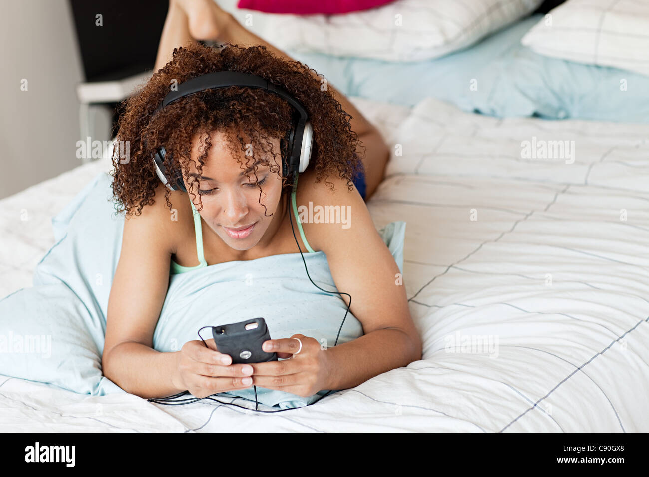 Woman listening to music on mp3 player Stock Photo