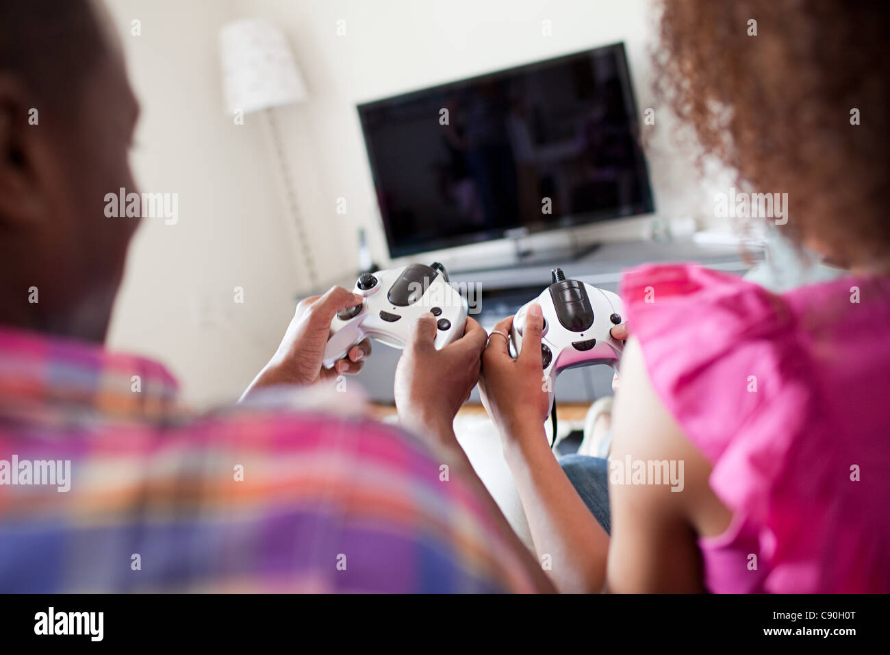 Couple playing video game at home Stock Photo
