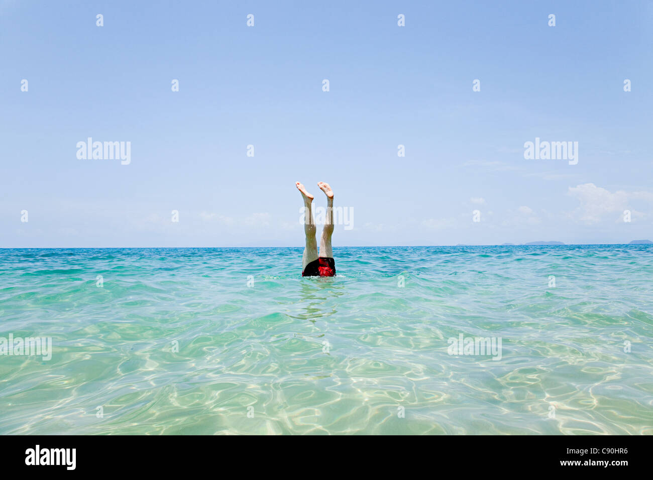 Swimmer with legs sticking out of water off Penhentian Kecil, Perhentian Islands, Malaysia Stock Photo