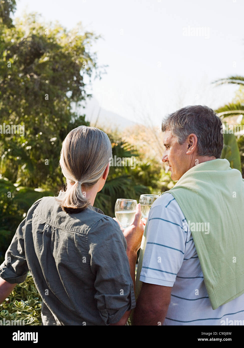 Couple looking at view from garden Stock Photo
