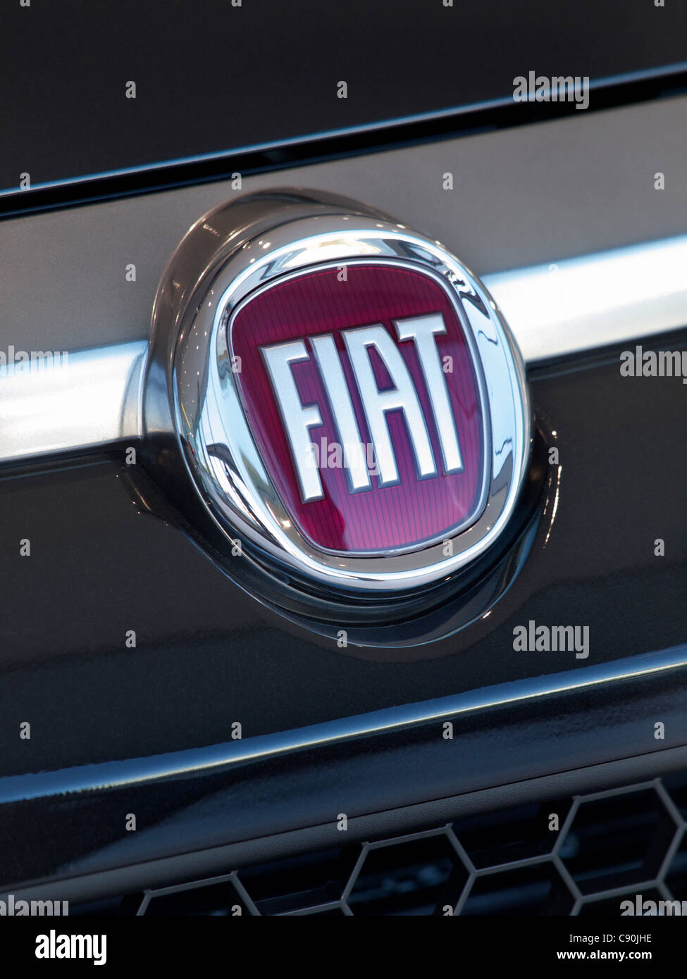 Fiat logo badge on the front of a Fiat Punto car. Fiat is an acronym and stands for Fabbrica Italiana Automobili Torino Stock Photo