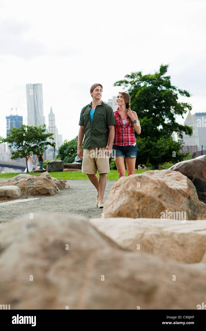 Young couple walking in city park Stock Photo
