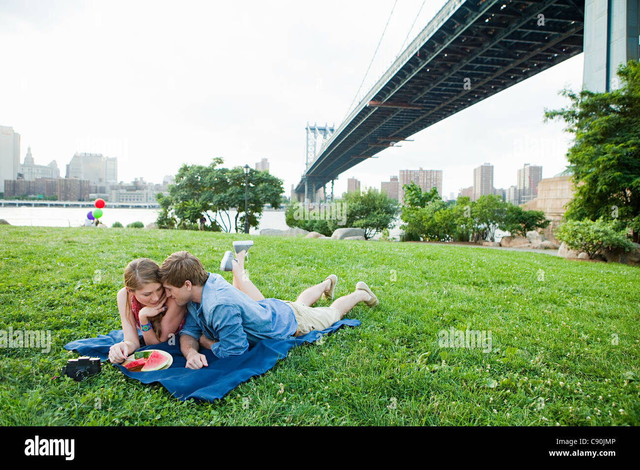 Young couple having picnic in a park Stock Photo