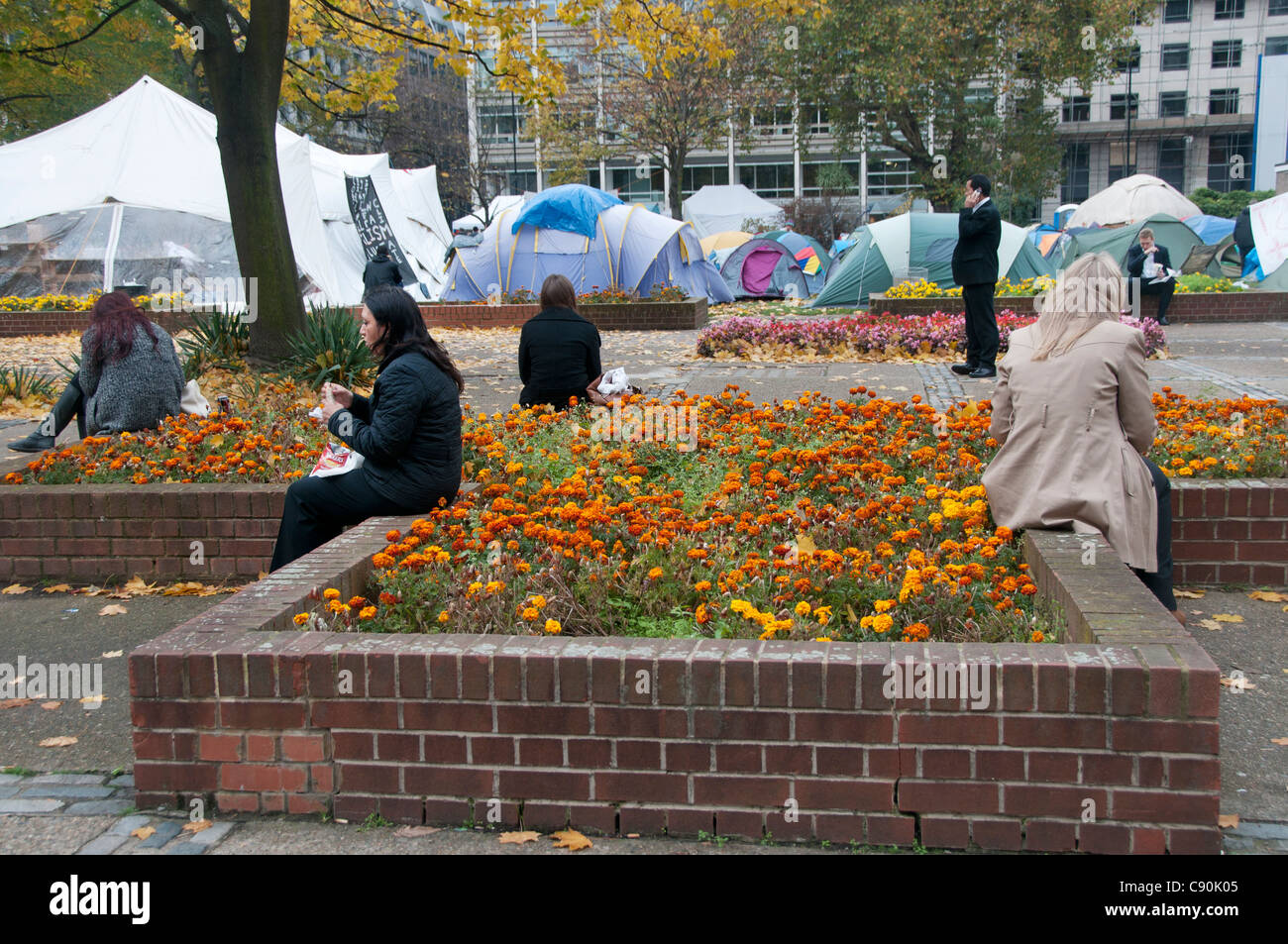 Occupy London Camp November 3rd 2011 Finsbury Square. City workers having lunch with tents in background Stock Photo