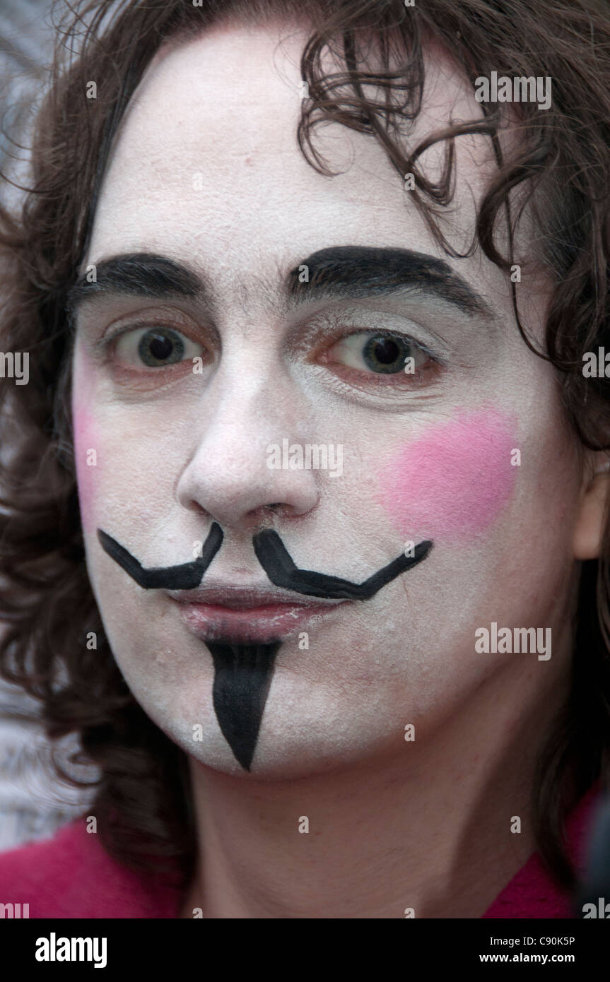 Protest against the city and banks. Protester wearing make-up to resemble Guy Fawkes and the mask from V for Vendetta Stock Photo