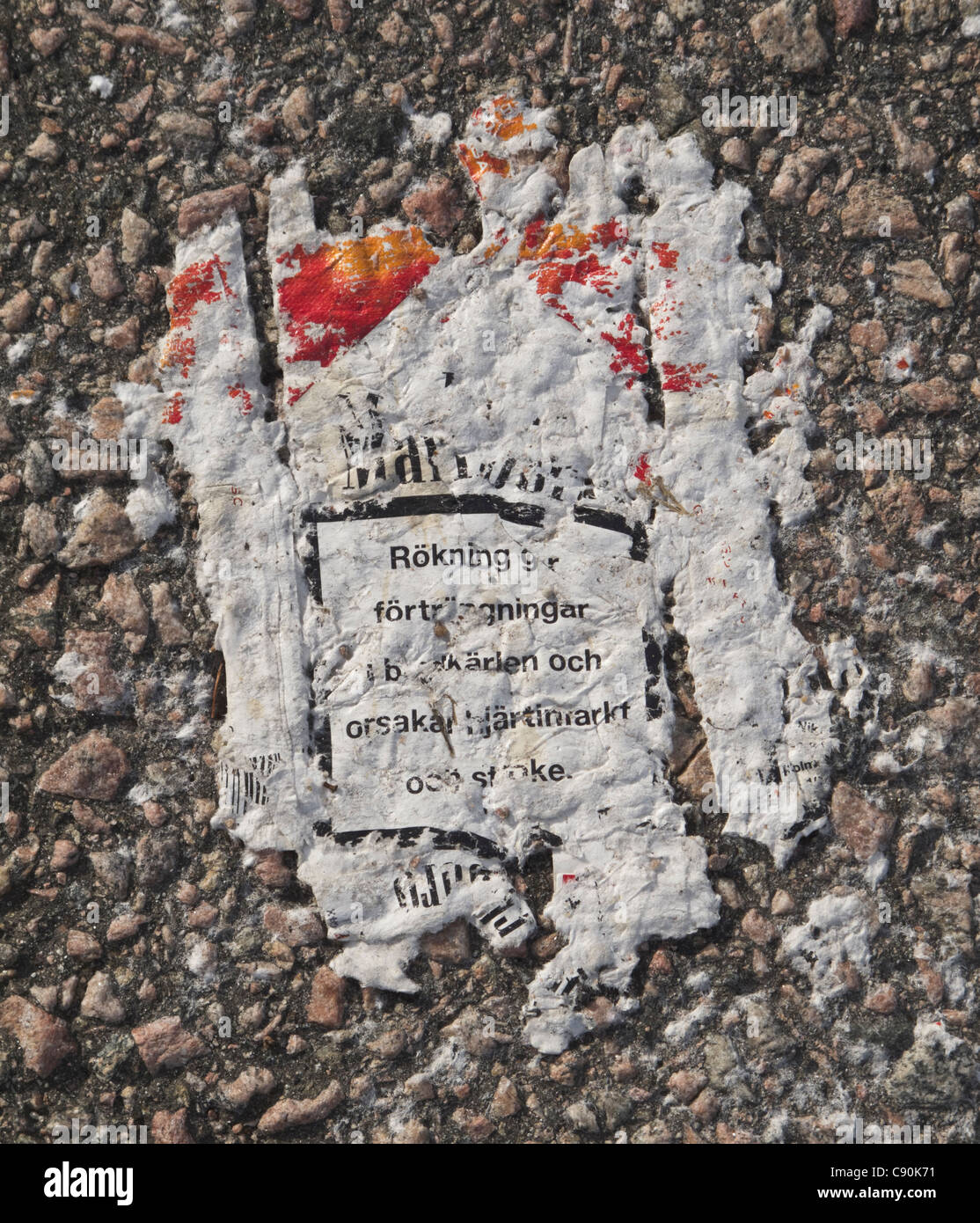 Worn Marlboro cigarette packet on the ground. Warning text in swedish. FOR  EDITORIAL USE ONLY Stock Photo