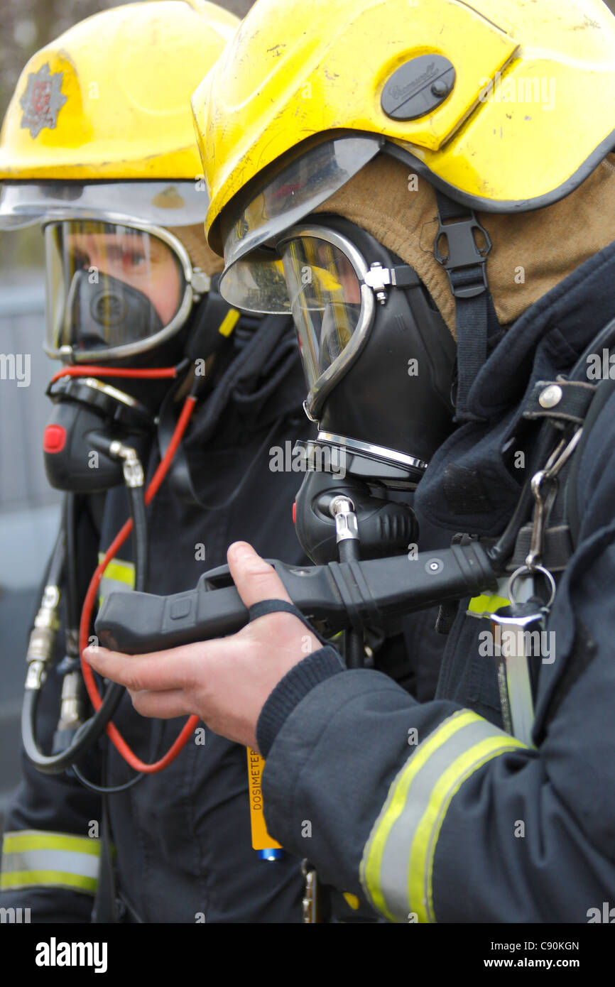 Firefighters checking breathing apparatus during a training exercise