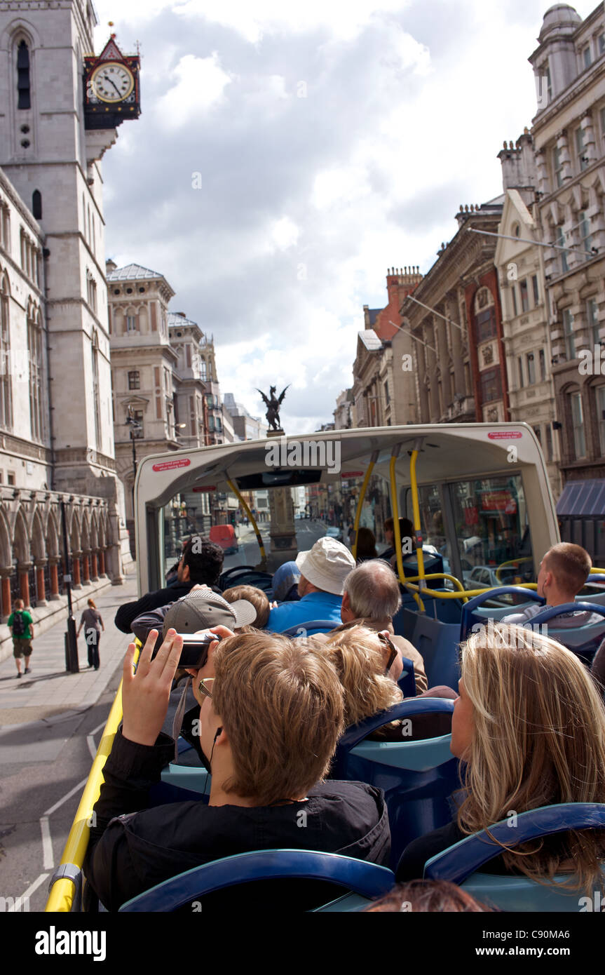 Tourists on an open-top bus, London, UK. Stock Photo
