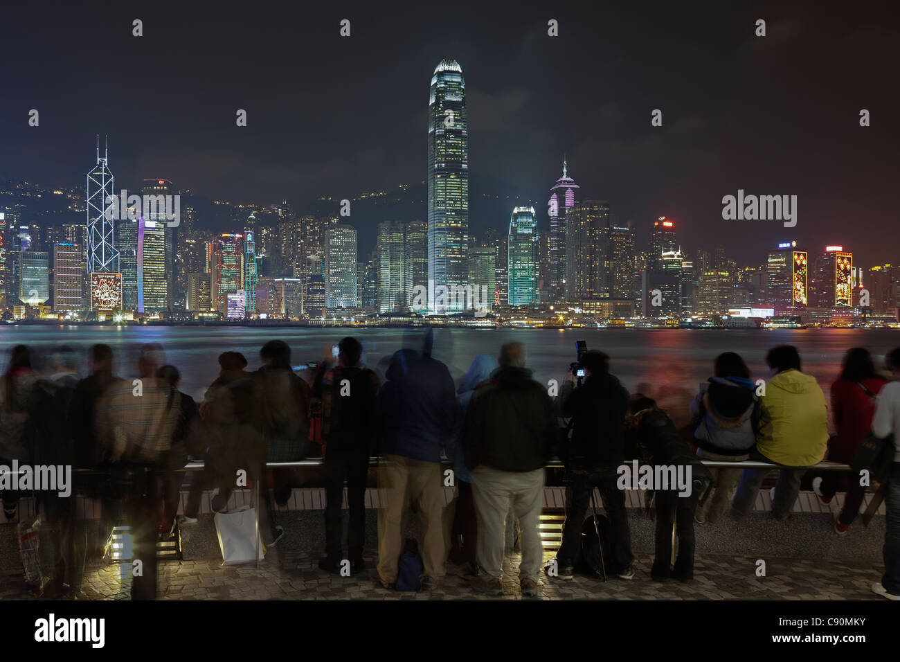 Hong Kong Skyline by night, tourists at Kowloon Public Pier, Kowloon, Hong Kong, China Stock Photo