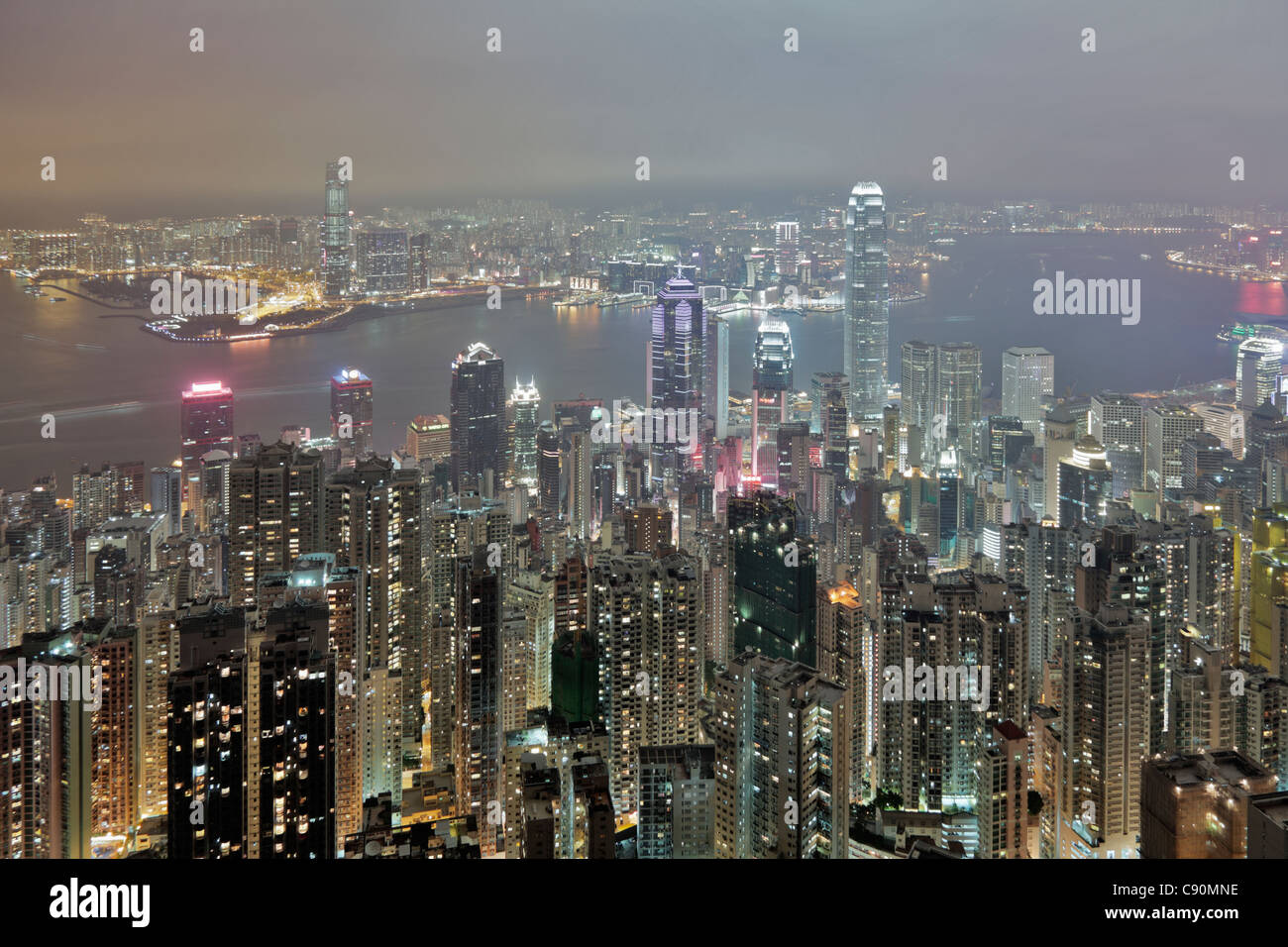 View of Hong Kong from Victoria Peak towards Victoria Harbour and the illuminated skyscrapers at night, Hong Kong, China Stock Photo