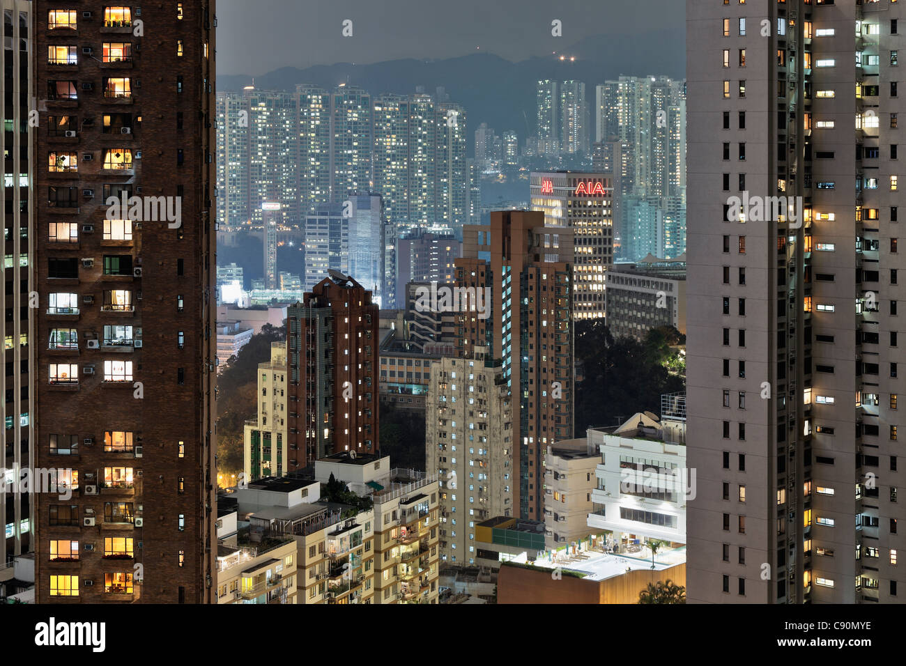Hong Kong housing estate and American International Assurance Centre at night, Hong Kong, China Stock Photo