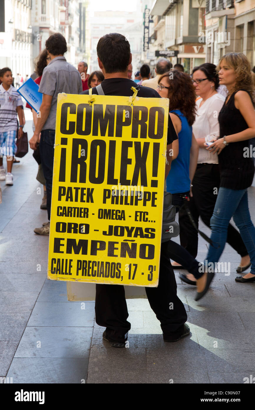 Man carrying advertising sandwich board "Buy Rolex" Madrid Spain Europe