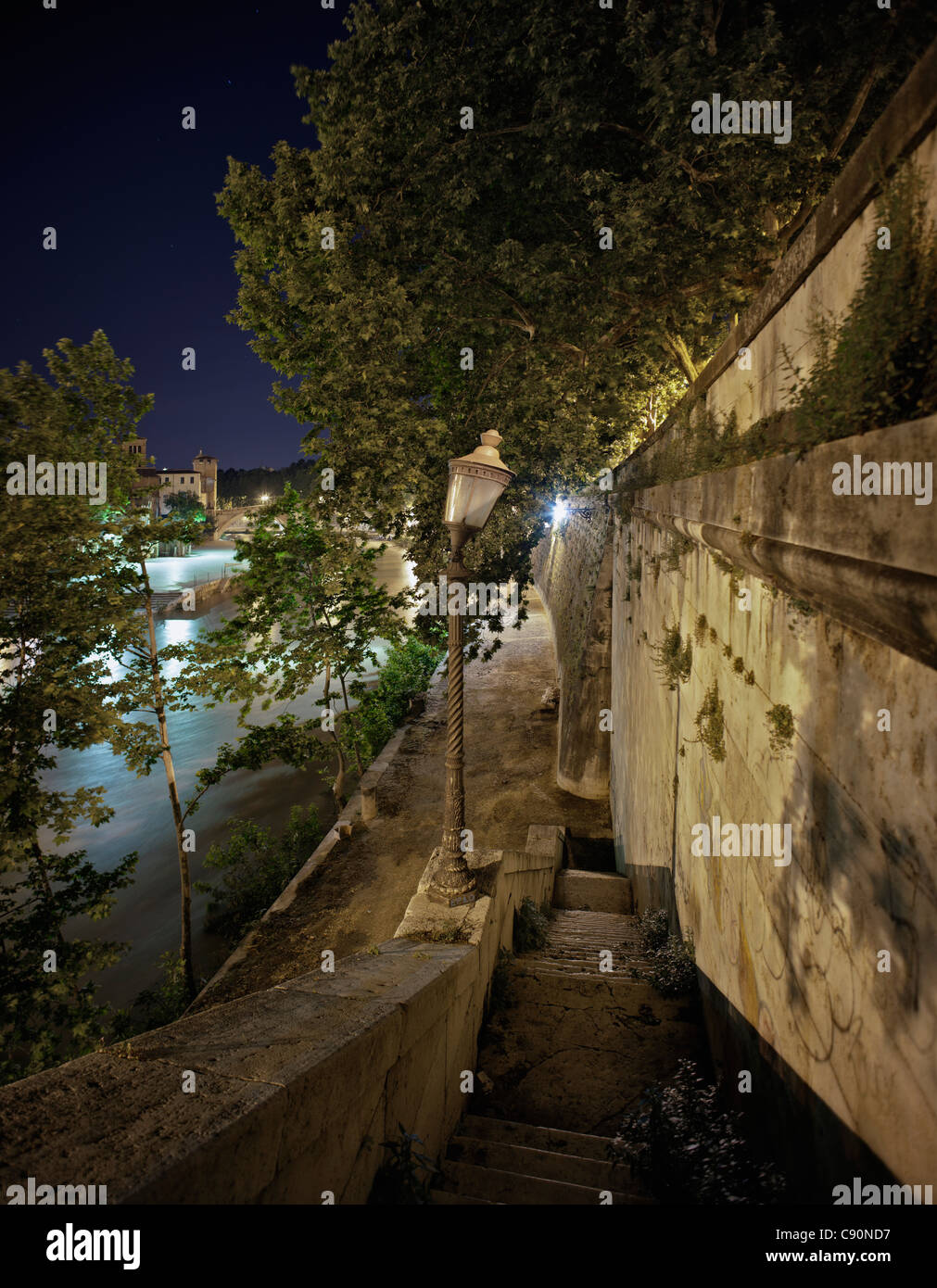 Stairs down to the Tiber River at night, Roma, Latium, Italy Stock Photo