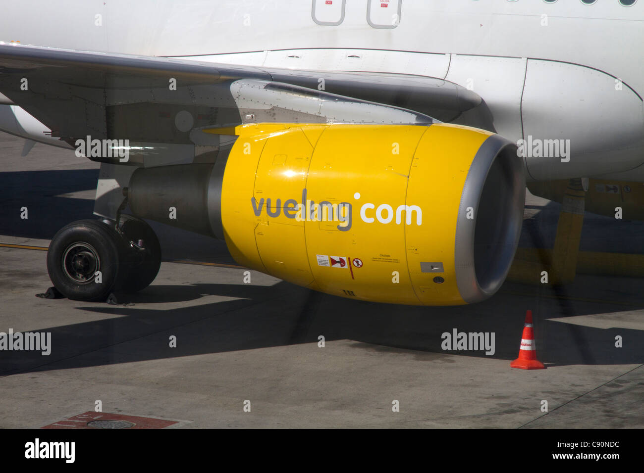Vueling sign on airplane motor, Vueling in a low-cost modern airline brand of Iberia Spain Stock Photo