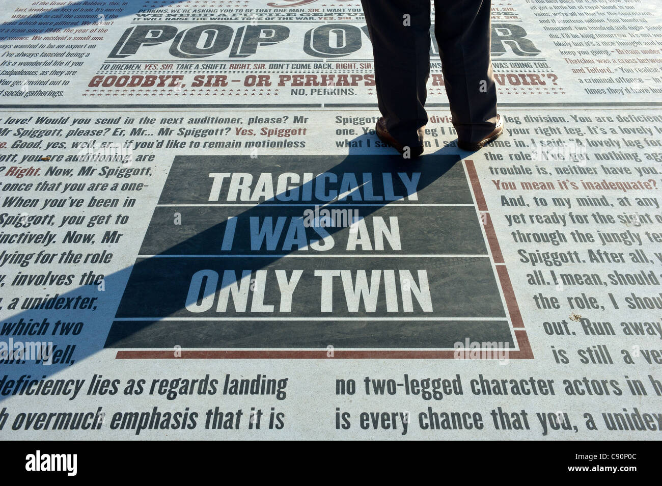 A man standing on the Comedy Carpet on Blackpool Promenade Stock Photo