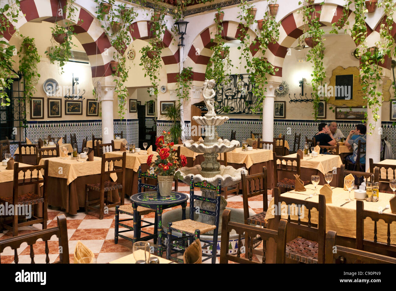 Courtyard interior of a restaurant in the old quarter, Cordoba, Spain Stock Photo