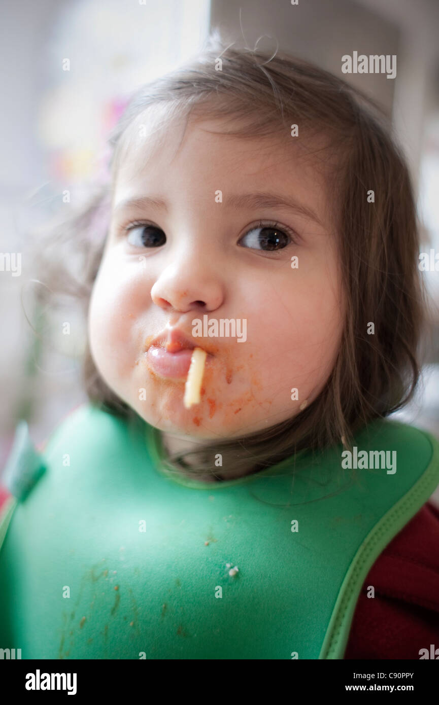 Toddler eating spaghetti Stock Photo