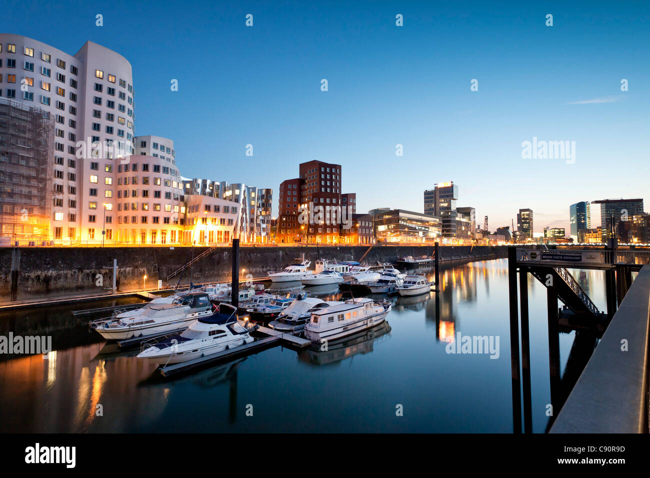 Buildings at Neuer Zollhof in the evening Frank O. Gehry Media Harbour at night Duesseldorf Duesseldorf North Rhine-Westphalia G Stock Photo