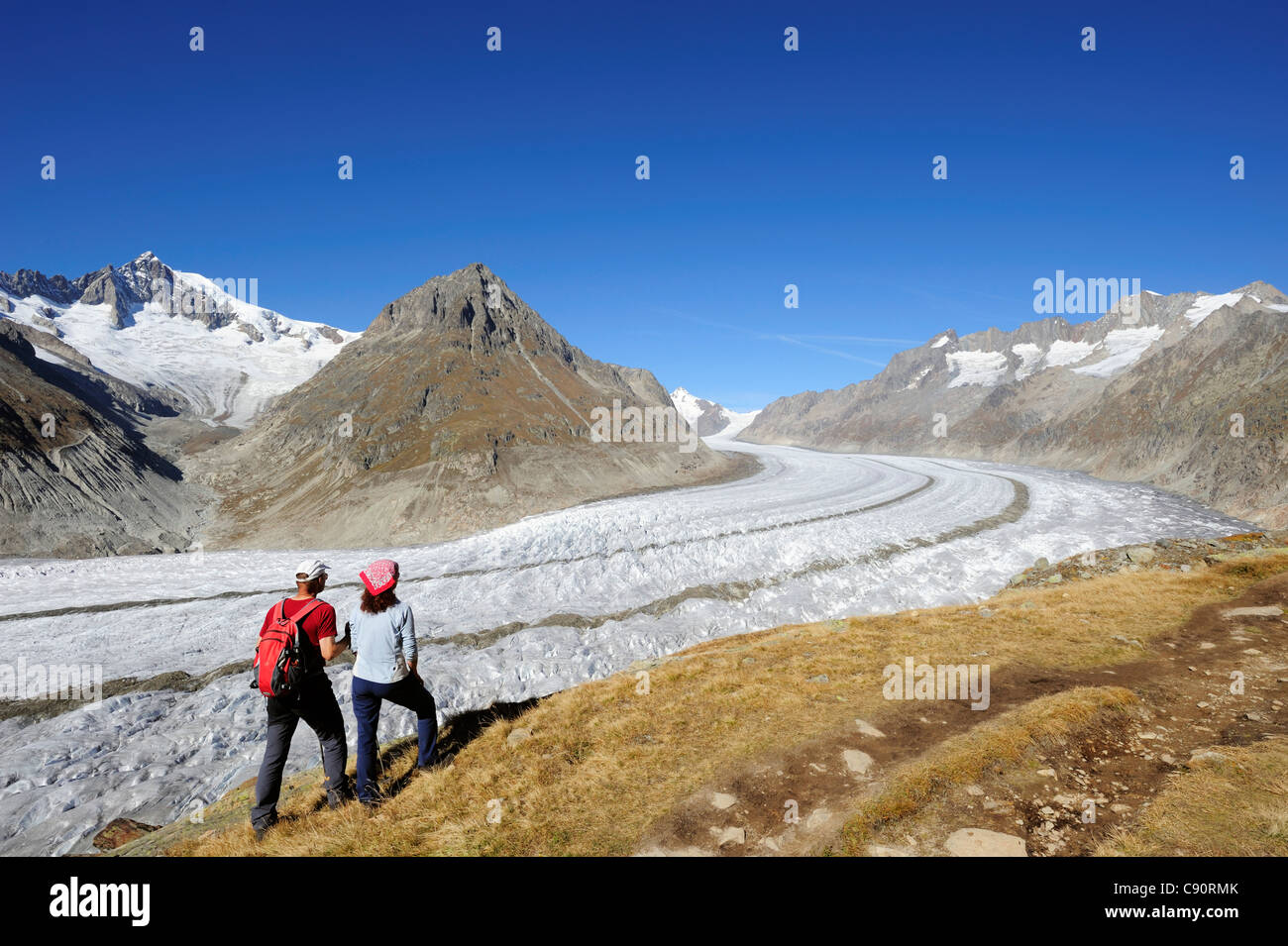 Couple looking towards glacier Grosser Aletschgletscher and Aletschhorn