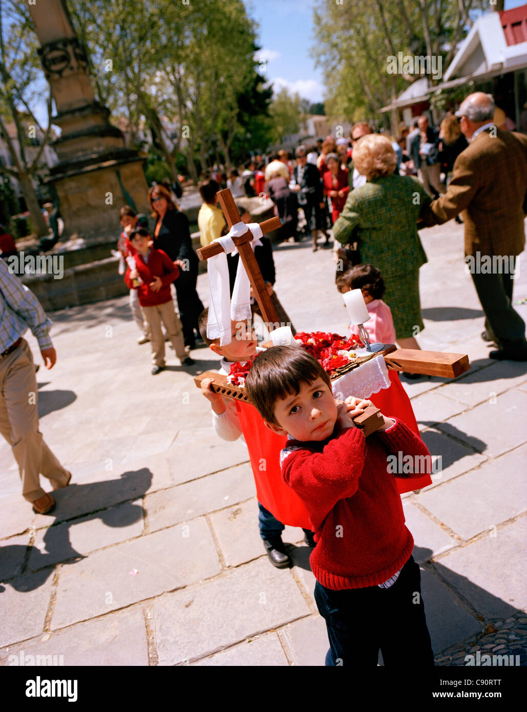 Kids carrying litter with cross, Cruzes de Mayo celebration, Baeza, Andalusia, Spain Stock Photo