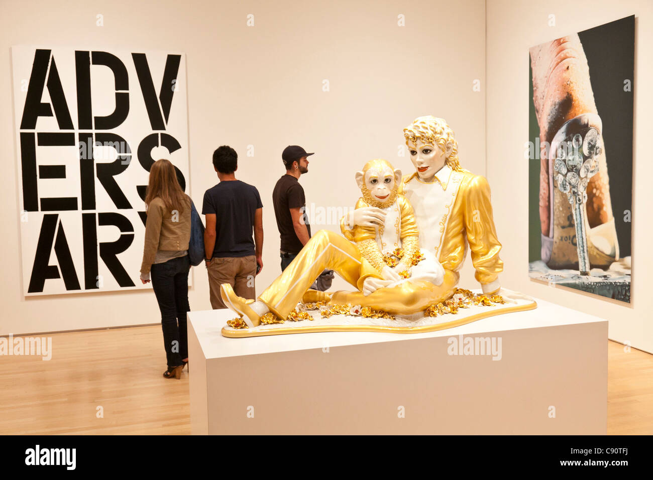 Sculpture Michael Jackson with his monkey gold figure modern art visitors avantgarde contemporary art San Francisco Museum of Mo Stock Photo