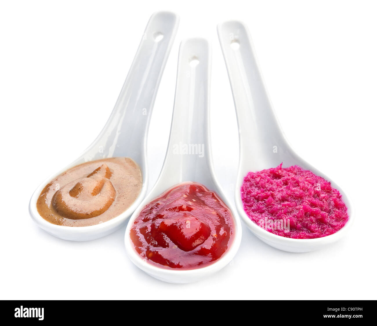 Hot Sauces in ceramic spoon isolated on white Stock Photo