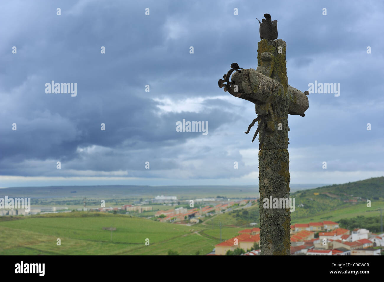 old cross and cloudly sky (Extremadura, Spain) Stock Photo