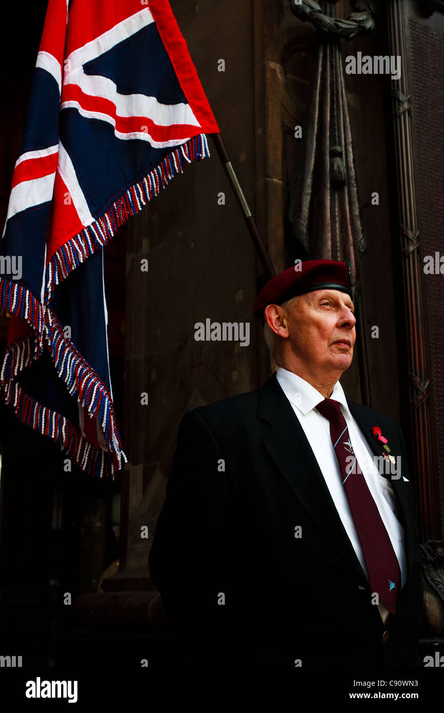 Bobby Esplin ex Paratrooper, standing at the Cenotaph in Central Railway Station, Glasgow, beside the Union Jack Flag, Stock Photo