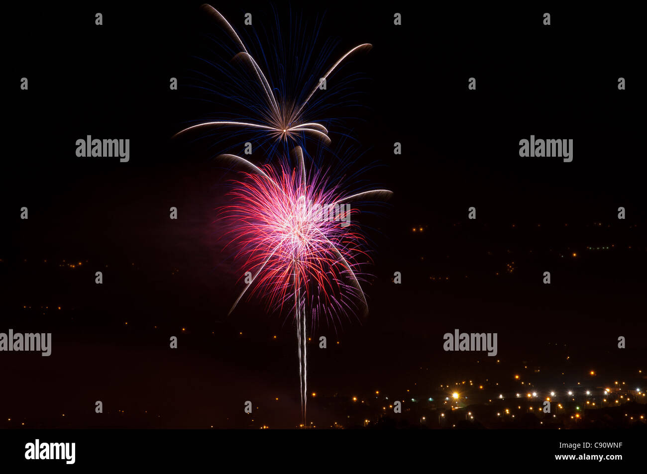 A celebration of fireworks on the fifth of November bonfire night, with a spectacular show of colors in the night time sky. Stock Photo